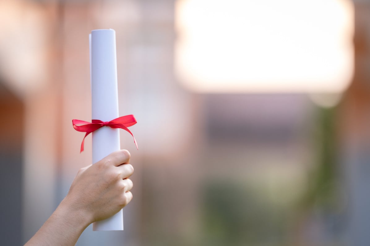 Graduate's Hand Holding a Diploma